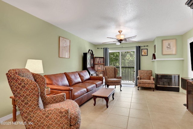 11 Arbor Club Dr Unit 212, Ponte Vedra Beach, FL 32082 - living room with a ceiling fan, a textured ceiling, light tile patterned floors, and a glass covered fireplace