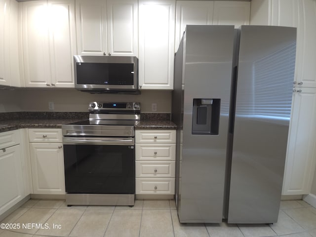kitchen featuring light tile patterned floors, white cabinetry, and stainless steel appliances