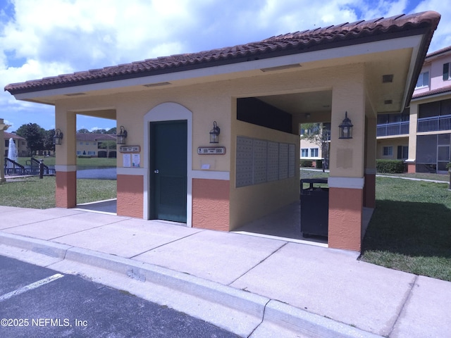 view of front of home with stucco siding and a tile roof