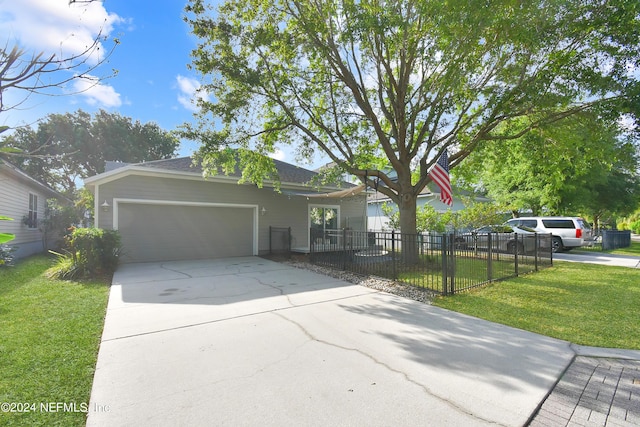 view of front of house with a garage, a front yard, driveway, and a fenced front yard
