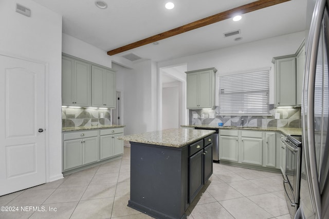 kitchen featuring a kitchen island, visible vents, appliances with stainless steel finishes, and light tile patterned floors