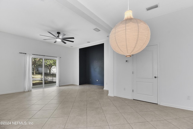 empty room featuring a ceiling fan, light tile patterned flooring, baseboards, and visible vents