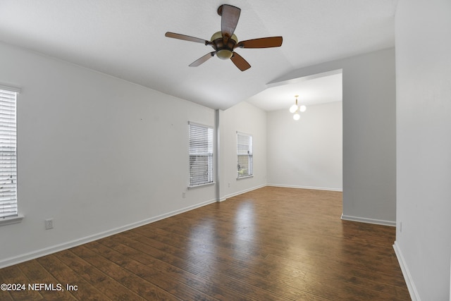 unfurnished room with a ceiling fan, baseboards, lofted ceiling, and wood finished floors