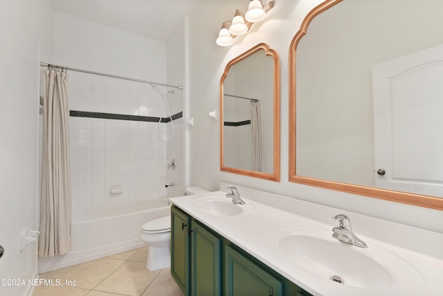 bathroom featuring toilet, a sink, tile patterned floors, and double vanity