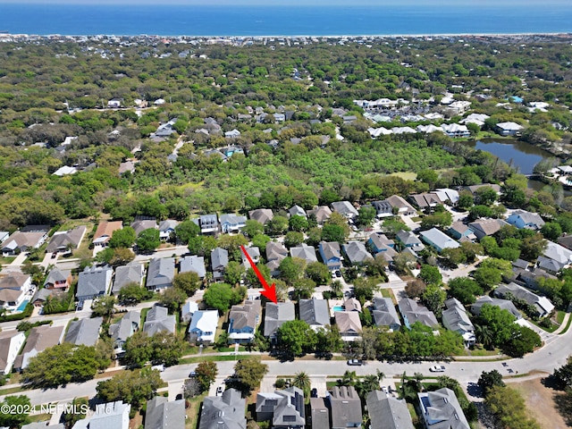 birds eye view of property with a water view and a residential view
