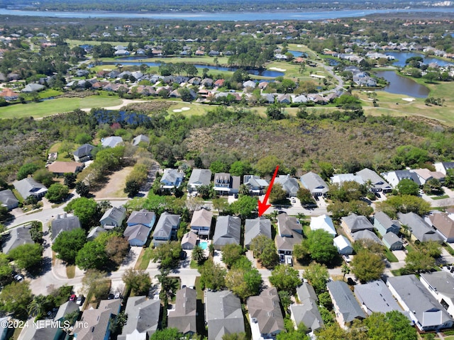 birds eye view of property with a water view, view of golf course, and a residential view