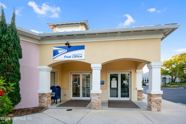 property entrance with french doors and stucco siding