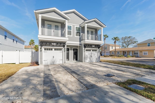 803 12th Ave S, Jacksonville Beach, FL 32250 - view of front facade with a balcony, fence, a garage, and driveway