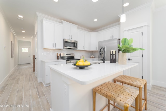 803 12th Ave S, Jacksonville Beach, FL 32250 - kitchen featuring a sink, stainless steel appliances, recessed lighting, white cabinetry, and light wood-style flooring