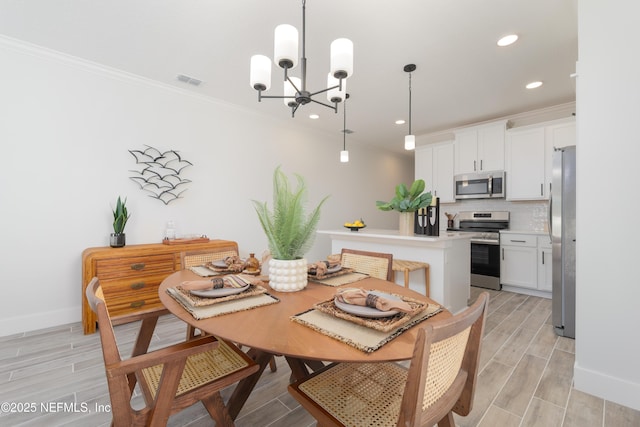 803 12th Ave S, Jacksonville Beach, FL 32250 - dining area with a chandelier, recessed lighting, wood finish floors, baseboards, and crown molding
