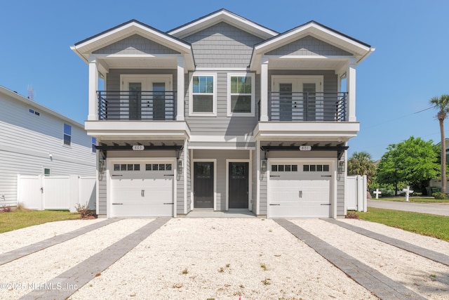 803 12th Ave S, Jacksonville Beach, FL 32250 - view of front of house with a balcony, a garage, and gravel driveway