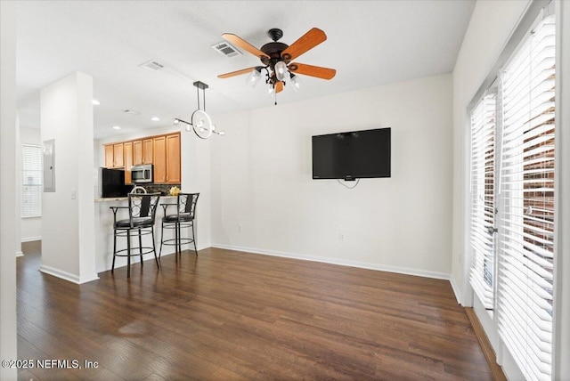 1492 Fieldview Dr, Jacksonville, FL 32225 - living room featuring electric panel, dark wood finished floors, baseboards, visible vents, and ceiling fan
