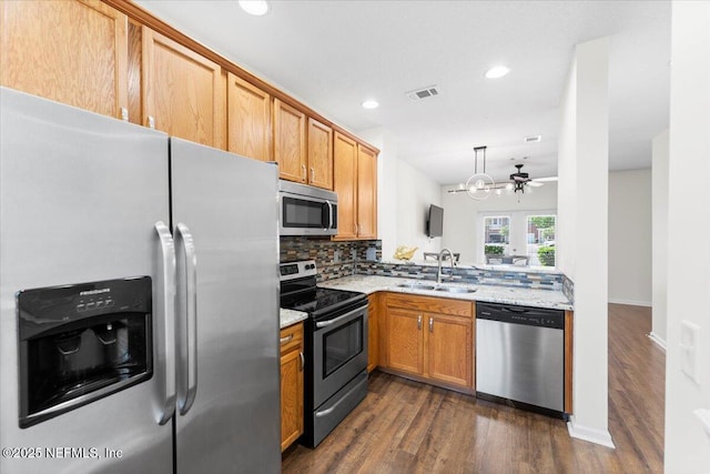 1492 Fieldview Dr, Jacksonville, FL 32225 - kitchen featuring visible vents, stainless steel appliances, a sink, dark wood-style floors, and backsplash