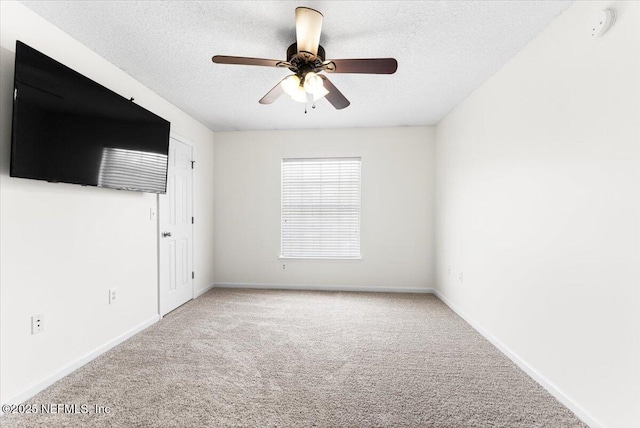 1492 Fieldview Dr, Jacksonville, FL 32225 - spare room featuring baseboards, a textured ceiling, ceiling fan, and light carpet