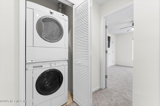 1492 Fieldview Dr, Jacksonville, FL 32225 - clothes washing area featuring stacked washer and dryer, light carpet, laundry area, baseboards, and ceiling fan