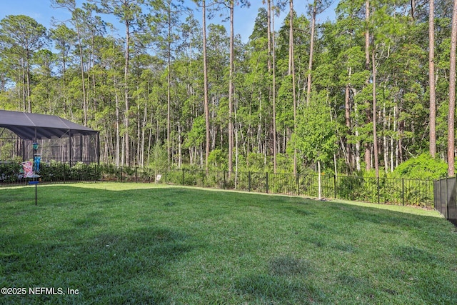 view of yard featuring a fenced backyard and a lanai