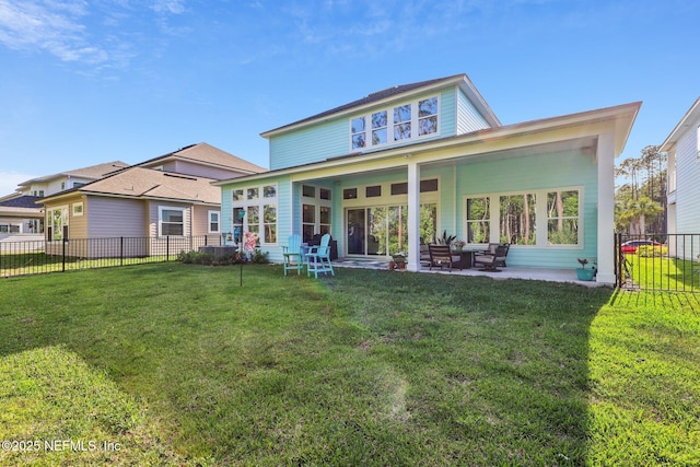 rear view of property with a yard, fence, and a patio area