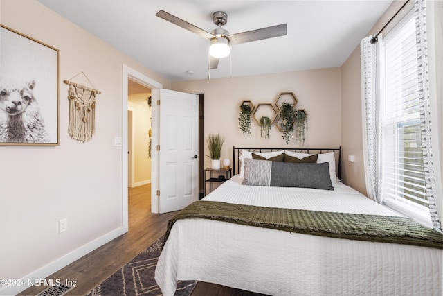 bedroom featuring baseboards, ceiling fan, and wood finished floors