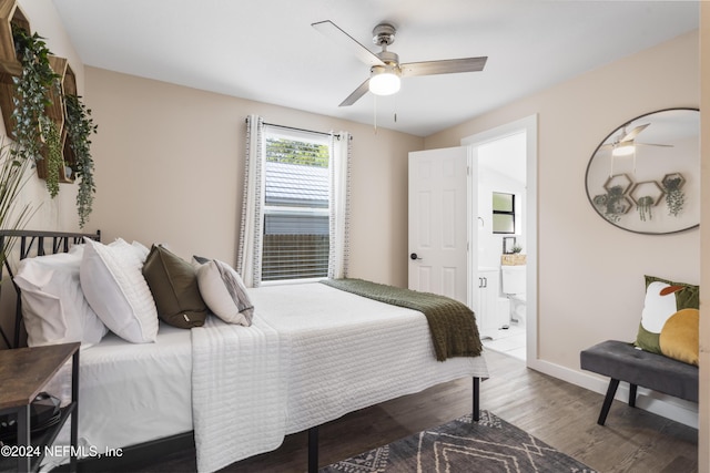 bedroom featuring ensuite bathroom, baseboards, ceiling fan, and wood finished floors