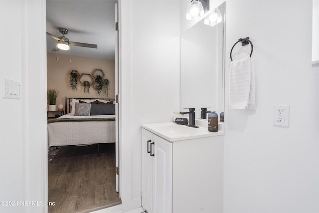 bathroom with vanity, ensuite bathroom, wood finished floors, and a ceiling fan
