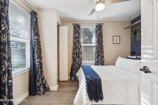 bedroom featuring baseboards, ceiling fan, and wood finished floors
