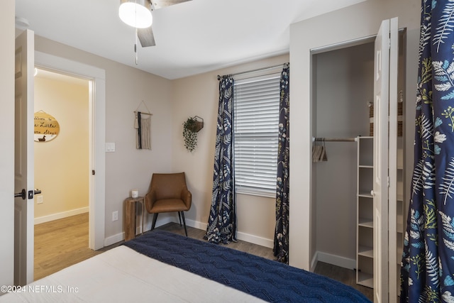 bedroom with baseboards, wood finished floors, and ceiling fan