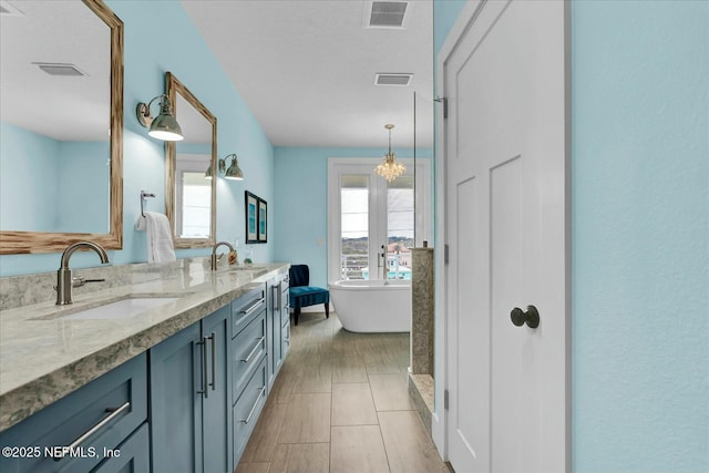 full bathroom with a sink and visible vents