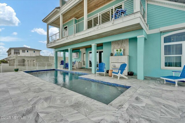 pool featuring fence and a patio