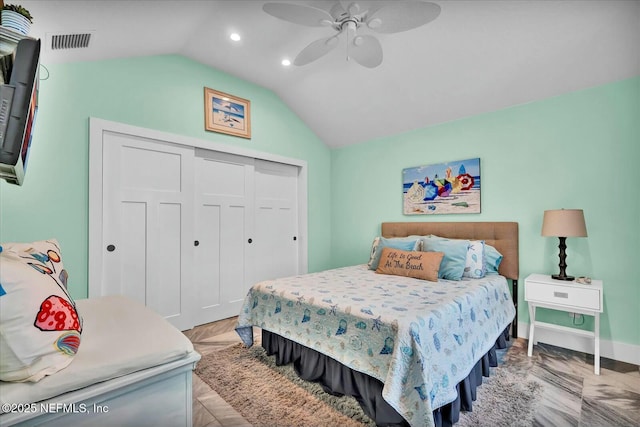 bedroom with a closet, visible vents, baseboards, ceiling fan, and vaulted ceiling