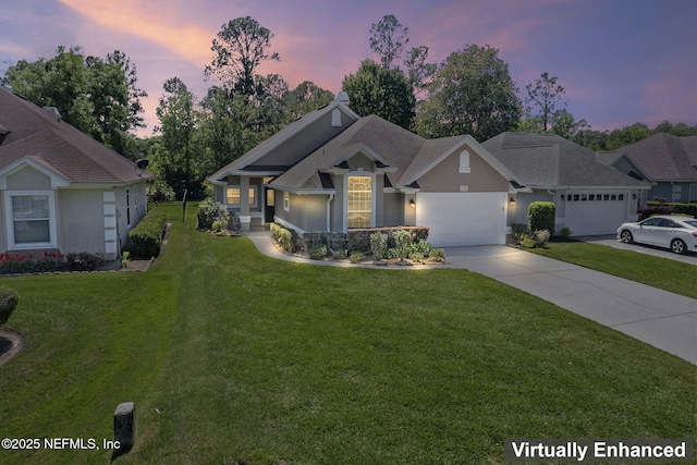 view of front of property with stucco siding, a front lawn, concrete driveway, and a garage