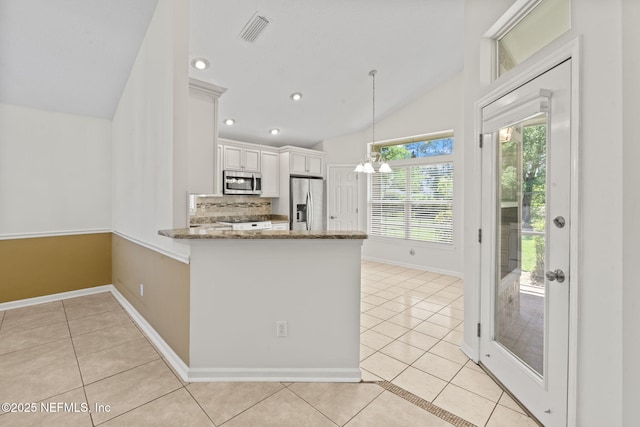 kitchen with light tile patterned floors, visible vents, stone countertops, and appliances with stainless steel finishes