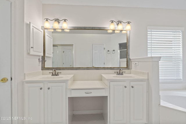 bathroom with a bath, double vanity, and a sink