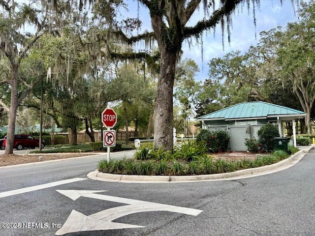 view of road with curbs and traffic signs