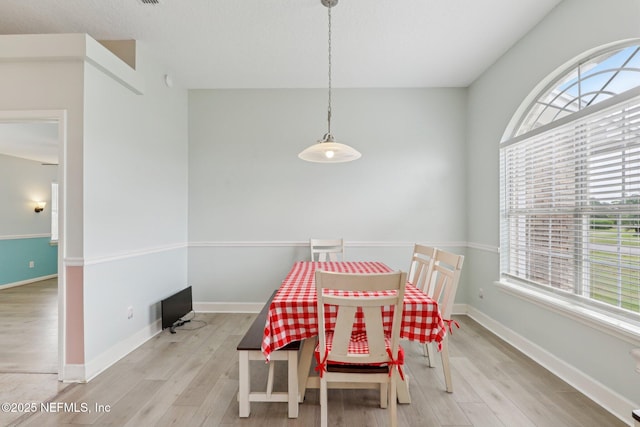 dining area featuring wood finished floors and baseboards
