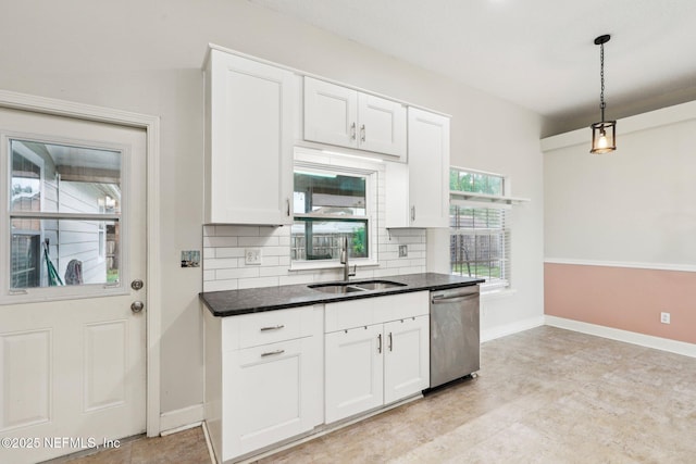 kitchen featuring stainless steel dishwasher, a sink, tasteful backsplash, white cabinets, and baseboards