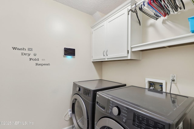 laundry area featuring cabinet space, independent washer and dryer, and a textured ceiling