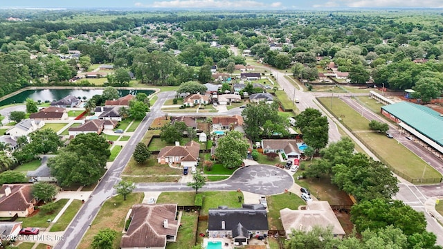 aerial view of property's location with a large body of water and nearby suburban area