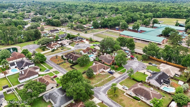 aerial overview of property's location with nearby suburban area and a heavily wooded area