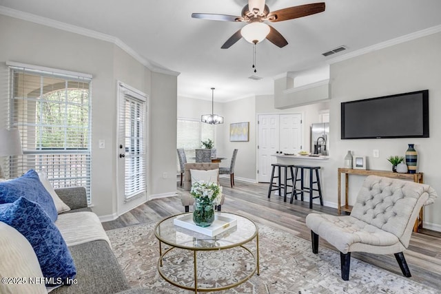 7800 Point Meadows Dr Unit 1511, Jacksonville, FL 32256 - living area featuring wood finished floors, ceiling fan with notable chandelier, and visible vents