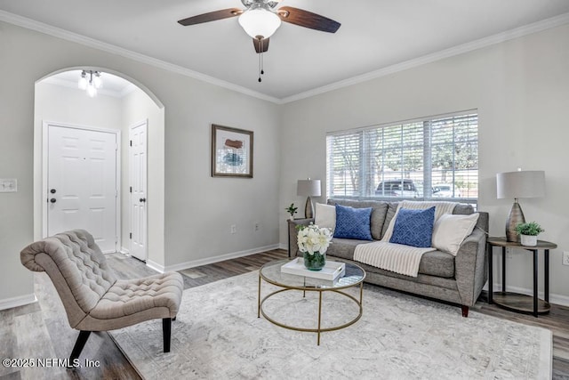 7800 Point Meadows Dr Unit 1511, Jacksonville, FL 32256 - living area featuring crown molding, baseboards, arched walkways, a ceiling fan, and wood finished floors