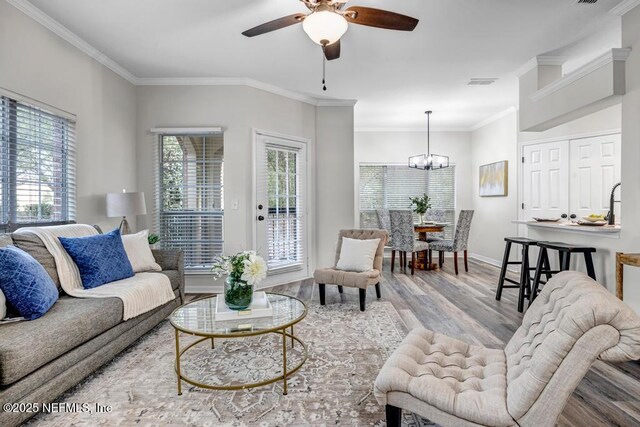 7800 Point Meadows Dr Unit 1511, Jacksonville, FL 32256 - living area with ceiling fan with notable chandelier, visible vents, wood finished floors, and ornamental molding