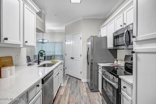 7800 Point Meadows Dr Unit 1511, Jacksonville, FL 32256 - kitchen featuring ornamental molding, a sink, stainless steel appliances, and white cabinetry