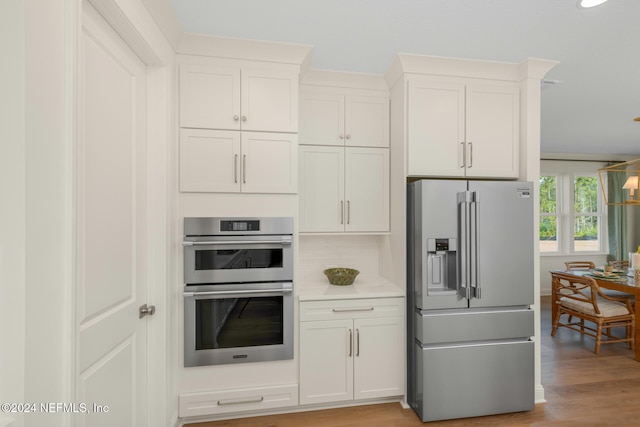 928 Caiden Dr, Ponte Vedra, FL 32081 - kitchen featuring stainless steel appliances, light wood-type flooring, light countertops, and white cabinetry