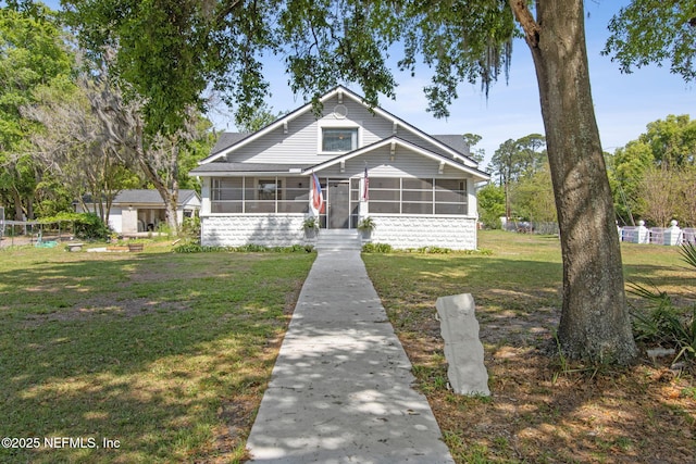 2541 Grand St, Jacksonville, FL 32208 - bungalow-style house featuring a front yard and a sunroom