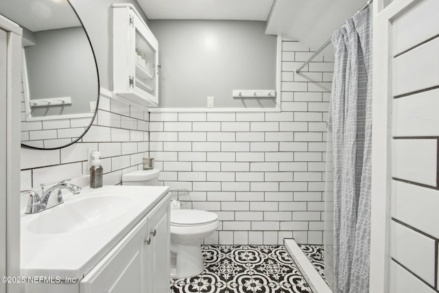 2541 Grand St, Jacksonville, FL 32208 - bathroom with toilet, tile walls, a shower stall, vanity, and tile patterned flooring