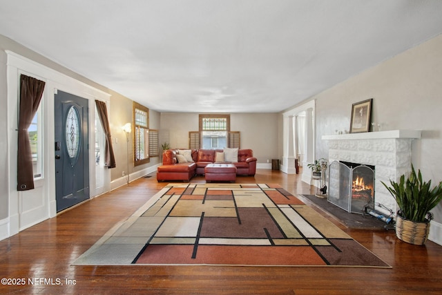 2541 Grand St, Jacksonville, FL 32208 - living area with a tiled fireplace, baseboards, and wood finished floors