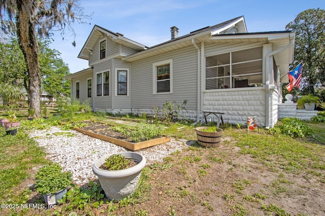 2541 Grand St, Jacksonville, FL 32208 - view of property exterior featuring a garden and a sunroom