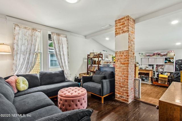 living area with visible vents, hardwood / wood-style floors, and lofted ceiling