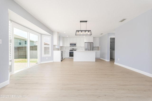 476 Monet Ave, Ponte Vedra, FL 32081 - unfurnished living room with baseboards, visible vents, a notable chandelier, and light wood-style floors