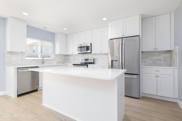 476 Monet Ave, Ponte Vedra, FL 32081 - kitchen featuring white cabinetry, light countertops, stainless steel appliances, and light wood-style floors